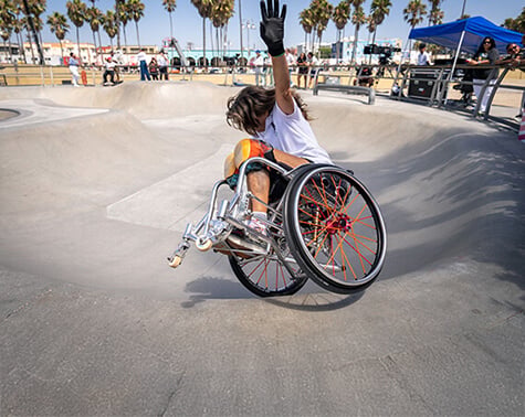 Tracie riding along the side of the bowl with one arm in the air